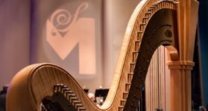 Harp with logo in background