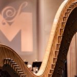 Harp with logo in background